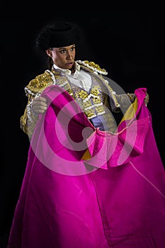 Woman bullfighter holding capote pink photo