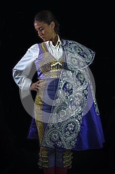 Woman bullfighter posing with capote walk purple photo