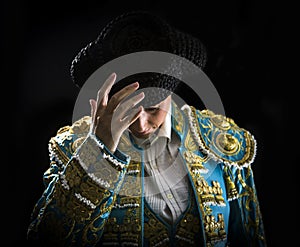 Woman bullfighter salutes with his montera photo