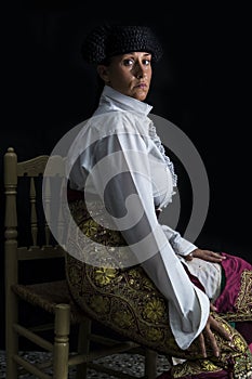 Woman bullfighter sitting