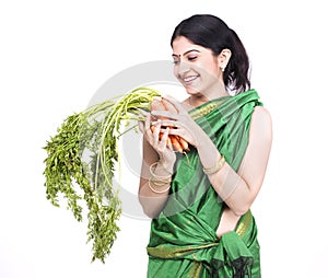 Woman with a bunch of carrots