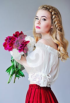 Woman with bunch of peonies