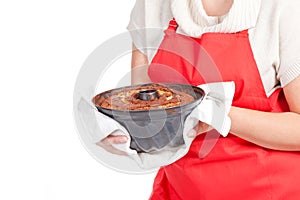 Woman with bundt cake and red apron