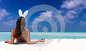 Woman with bunny ears and colorful easter eggs