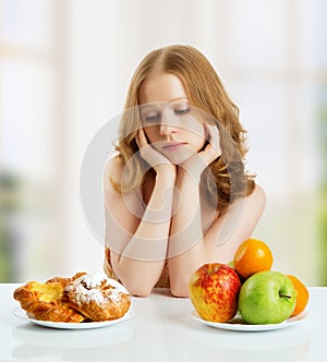 Woman choose between healthy and unhealthy food photo