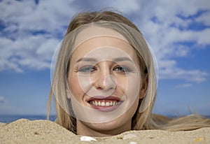 Woman buried in sand on beach