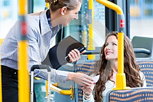 Woman in bus having no valid ticket at inspection