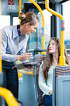 Woman in bus having no valid ticket at inspection