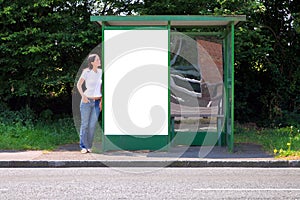 Woman at a bus stop blank billboard