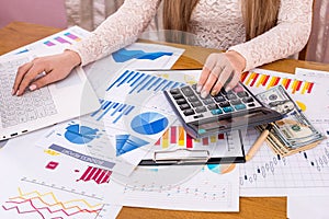 Woman business analyst calculating reports photo