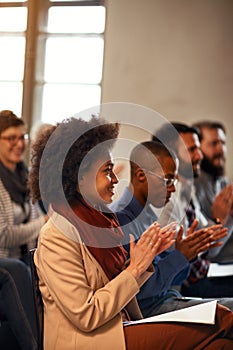 Woman on business convention applauding after presentation