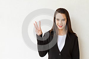 Woman business executive showing 3 or three fingers hand gesture