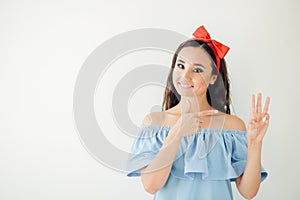 Woman business executive showing 3 or three fingers hand gesture