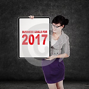 Woman with business goals for 2017 on board
