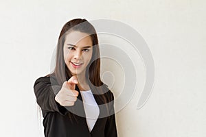 Woman in business suit hand pointing forward with text space