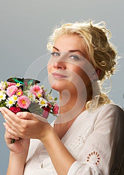 Woman with a butterfly over blue sky