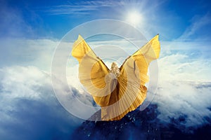Woman Butterfly Wings Flying in Sky Clouds, Girl Standing on Mountain Peak, in Flight to Sun photo