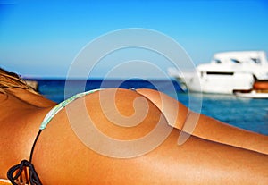 woman buttocks on the beach background