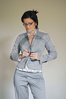 Woman Buttoning or Unbuttoning Suit