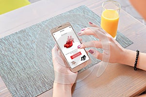 Woman buy red shoes online . Mobile app or web site on screen