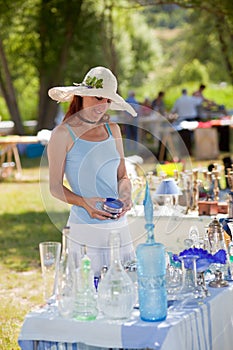 Woman buying antique collectibles, Provence, France.