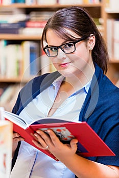 Woman buying books in bookstore