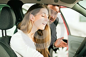 Woman buying car from salesperson