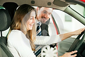 Woman buying car from salesperson