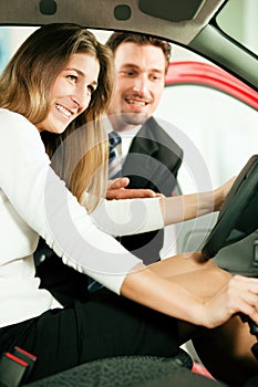 Woman buying car from salesperson