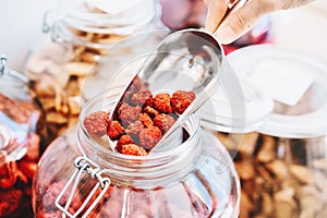 Woman buying dried fruits and berries in plastic free store