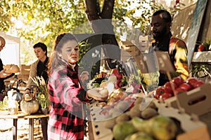 Woman buying fresh locally grown seasonal fruits and veggies