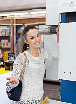 Woman buying heating water boiler