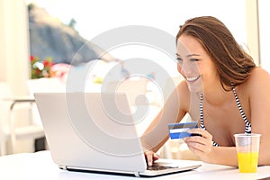 Woman buying online on vacations photo