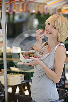 Woman buying strawberries at farmer's market