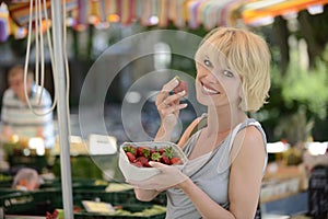 Woman buying strawberries at farmer's market