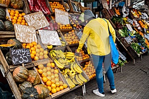 Woman Buying in Street Market