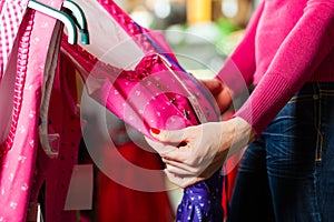 Woman is buying Tracht or dirndl in a shop