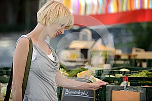 Woman buying vegetables at farmer's market