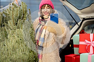 Woman buys Christmas tree and presents at mall