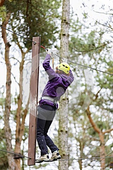 Woman on cables in an adventure park
