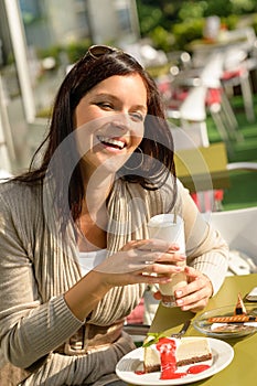 Woman at cafe bar holding latte drink photo
