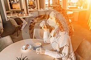 Woman cafe coffee breakfast. Portrait of an adult beautiful woman in an elegant suit in a cafe
