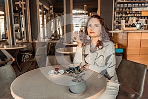 Woman cafe coffee breakfast. Portrait of an adult beautiful woman in an elegant suit in a cafe