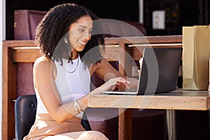 Woman, cafe and laptop with smile, shopping and ecommerce on internet sale, discount or deal. Black woman, happy and