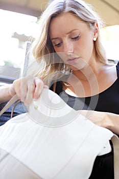 woman in cafe looking in bag