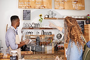 Woman, cafe and pointing at menu on wall with barista, notes and decision for good customer experience. Male waiter