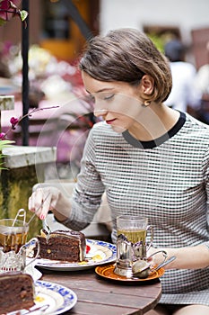 Woman at cafe wrap the cake with fork