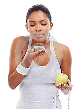 Woman, cake and fruit choice diet or smell dessert for weight loss, nutrition decision or balance food. Female person