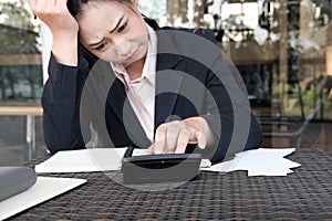 woman calculate domestic bills at home. Businesswoman using calculator at modern office. Young female checking balance & costs.