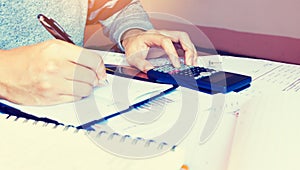 Woman calculate finance on desk with analyaing summary report at